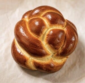 Rosh Hashanah Round Challah NYC by Crumbly Cafe & Bakery featuring a fresh-baked golden round challah