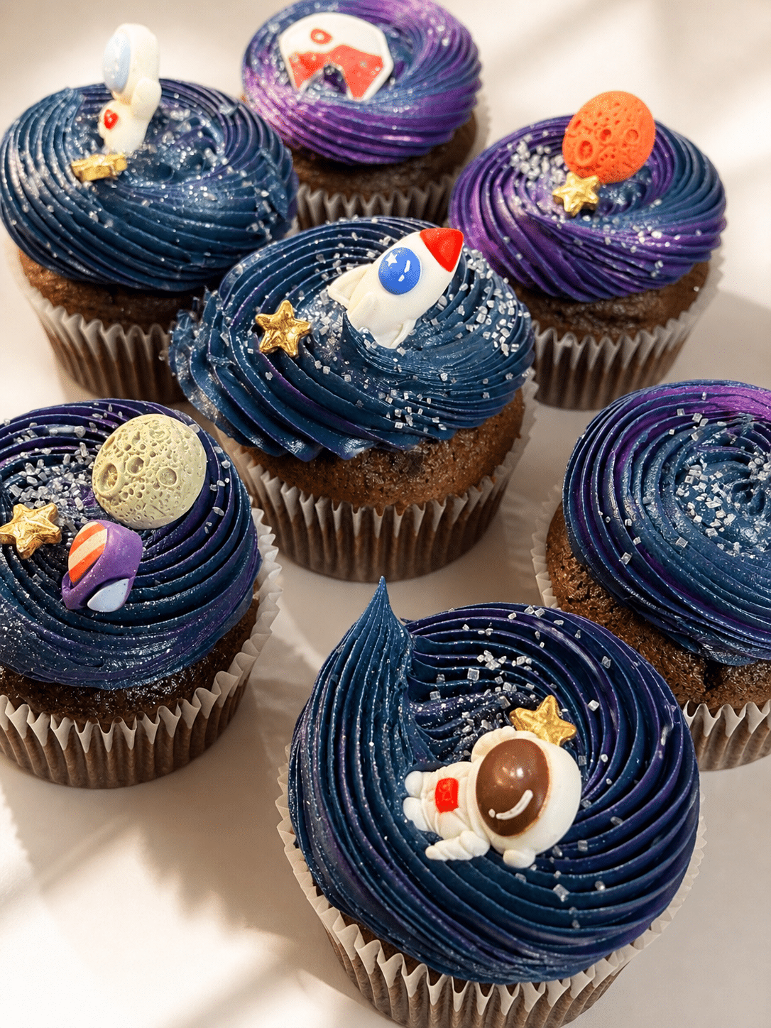Colorful Galaxy Cupcakes with cosmic buttercream swirls and space-themed decorations by Crumbly NYC