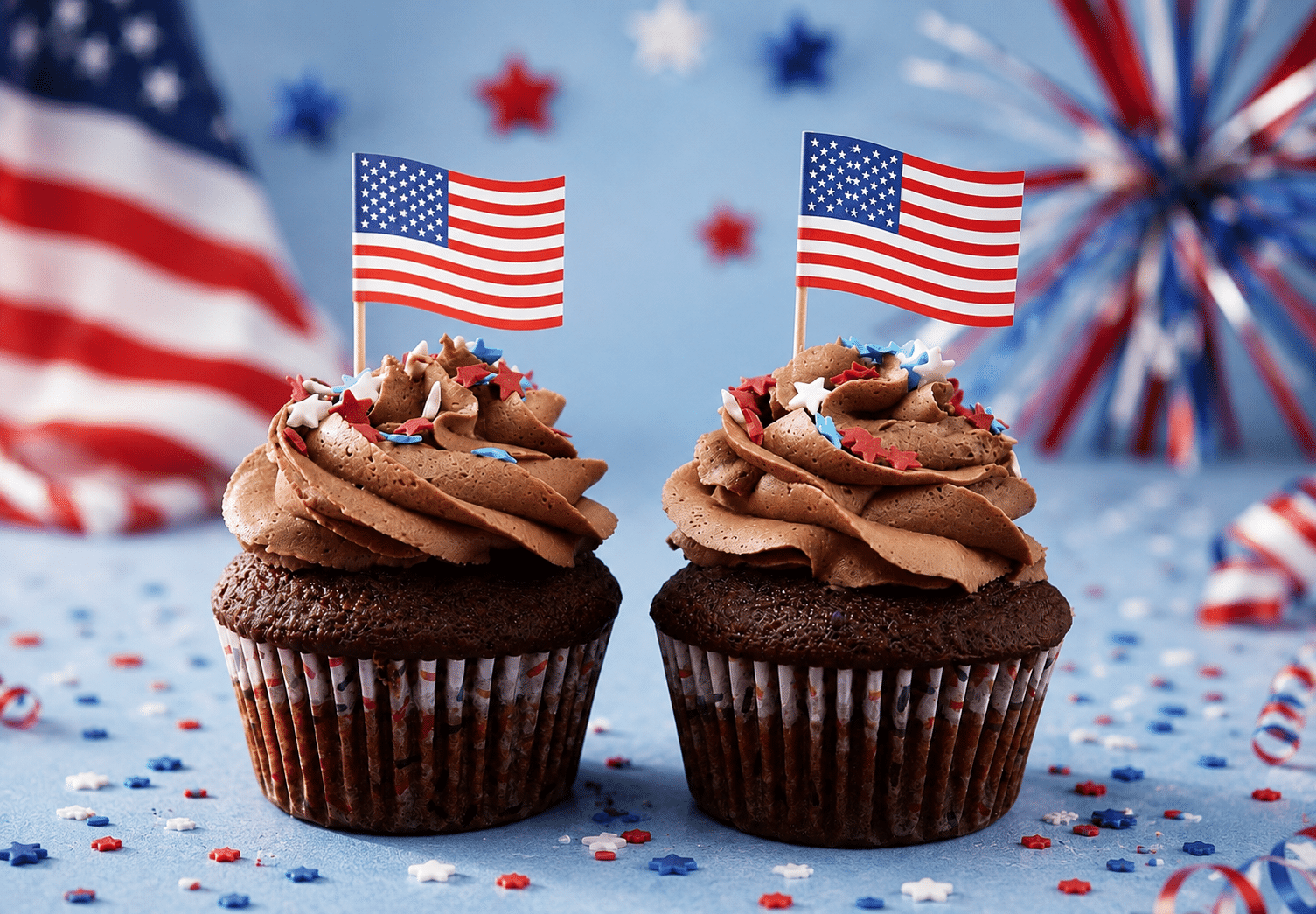 Patriotic Celebration Cupcakes with red, white, and blue sprinkles, stars, flags, and festive buttercream by Crumbly NYC